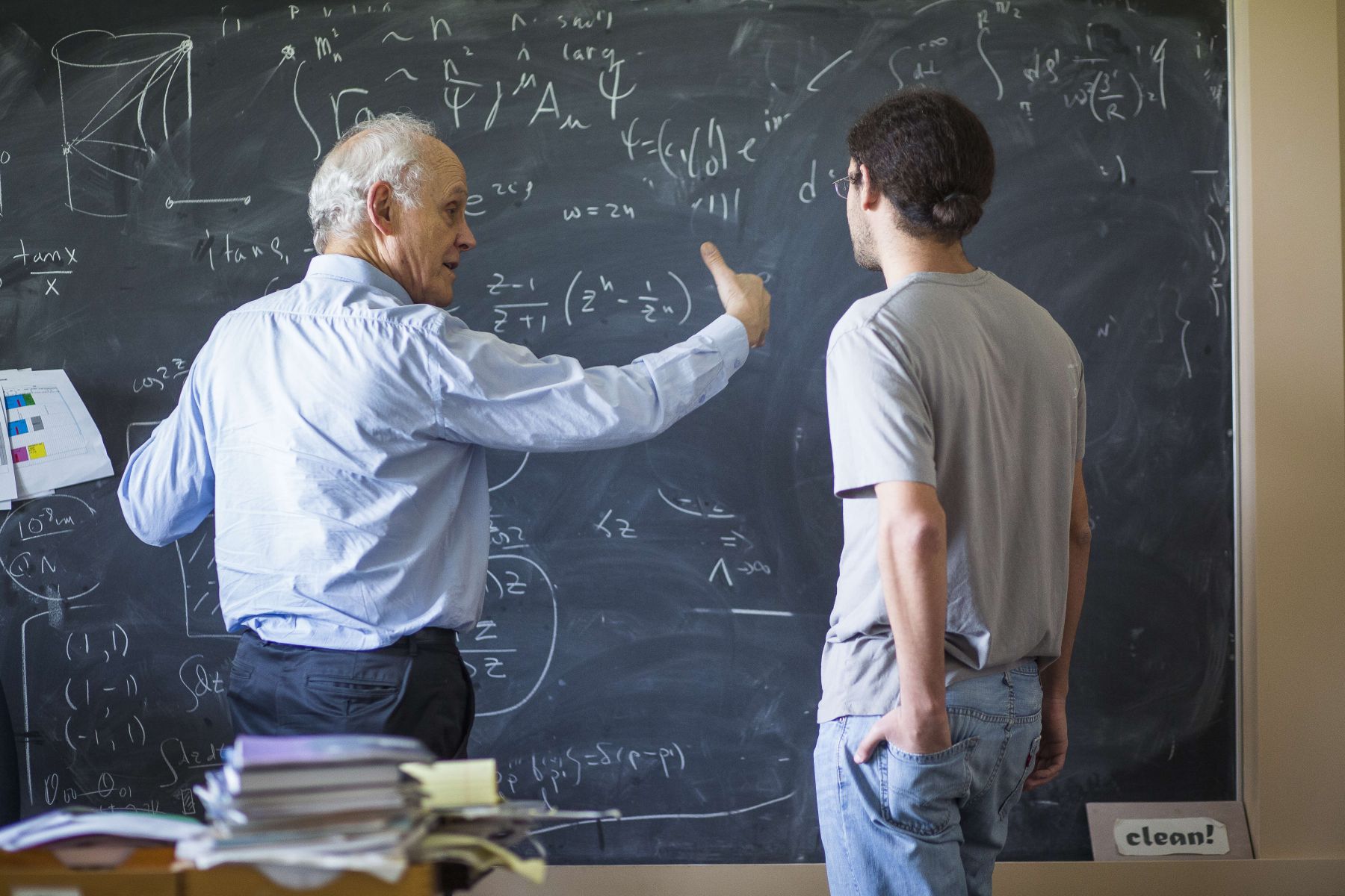 Two physicists at a blackboard