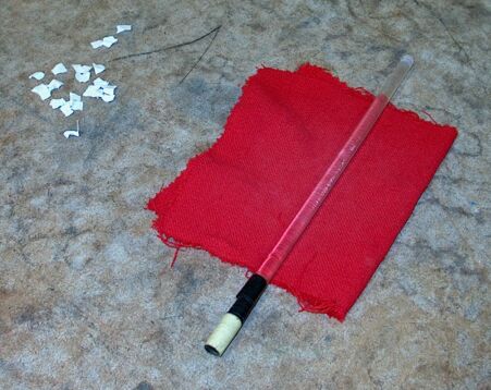 Paper bits, charged rod